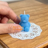 Real functioning miniature teddy bear candles in blue with burnable wicks, cute bear-shaped candles for miniature displays and dollhouse decorations by Real Mini World.