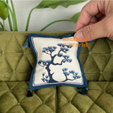 Handcrafted miniature navy blue and ivory chinoiserie sofa cushion featuring an elegant blue bonsai tree motif, decorative tassel corners and contrasting fabric border, luxury dollhouse living room accessory by Real Mini World.