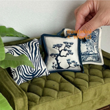 Handcrafted miniature blue and white chinoiserie sofa cushions featuring elegant botanical tree patterns and zebra print, luxury dollhouse furniture accessories by Real Mini World.