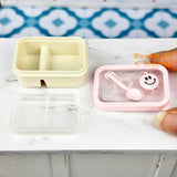 Caja bento en miniatura con cara sonriente