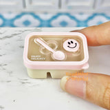 Caja bento en miniatura con cara sonriente