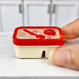 Caja bento en miniatura con cara sonriente