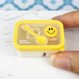 Caja bento en miniatura con cara sonriente