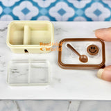 Caja bento en miniatura con cara sonriente