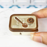 Caja bento en miniatura con cara sonriente