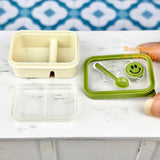 Caja bento en miniatura con cara sonriente